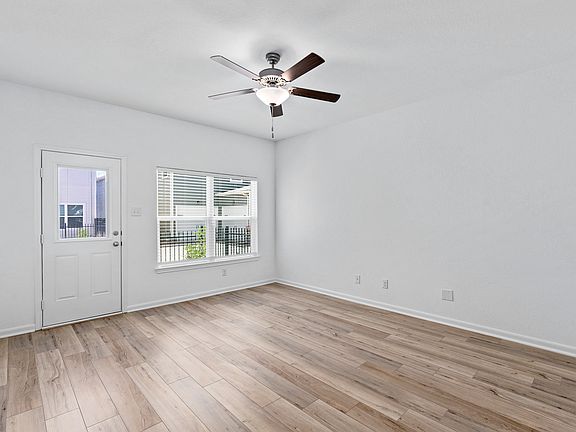 Open living room with windows to allow natural light in.