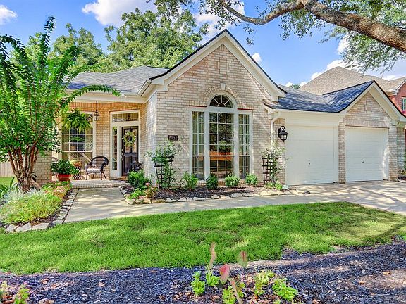 This charming home has amazing curb appeal with lots of shade, nice flower beds, and a large covered front porch.