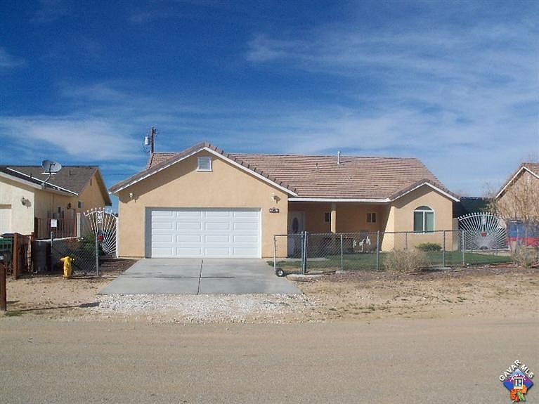 Front view - gated entry, gate slides and locks across front yard.