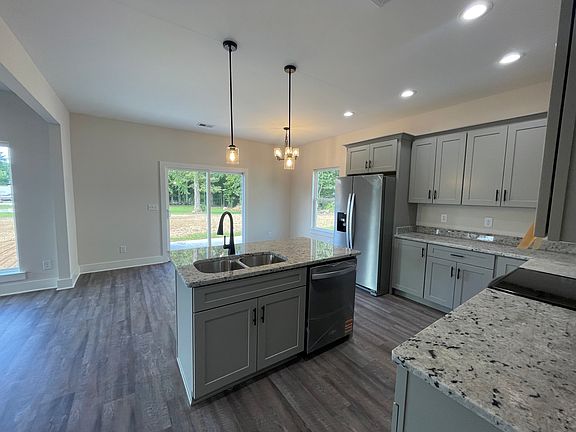 Kitchen with all new stainless appliances including refrigerator, stove, microwave and dishwasher