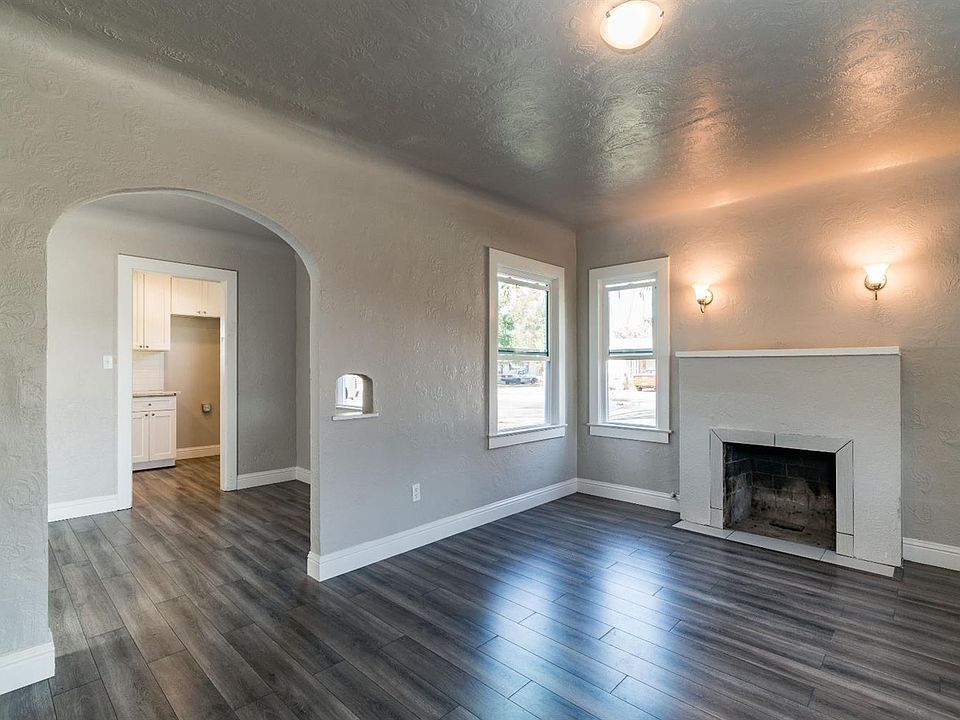Loving Room and dining room through the archway with kitchen