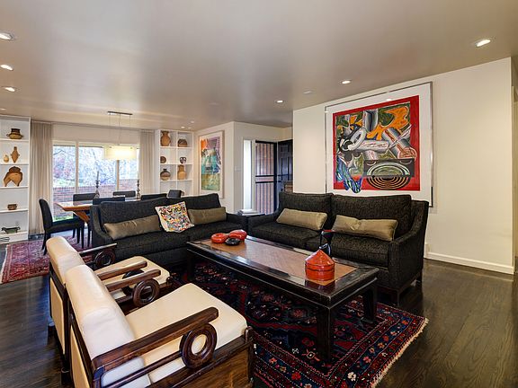 Open floor plan living room/ dining room with built-in shelving perfect for books and decor