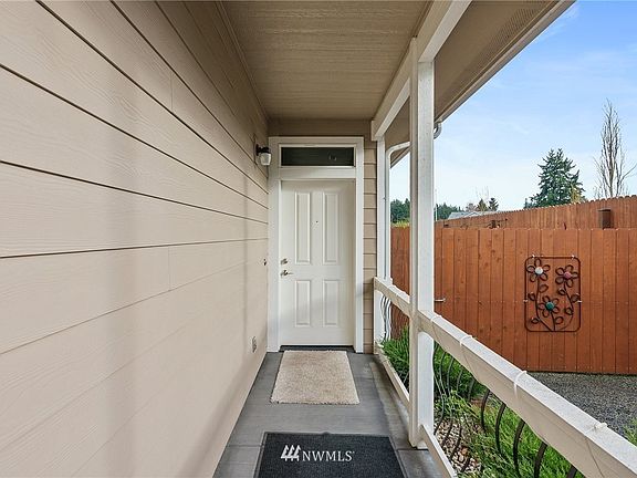 Covered entry and to the right is big enough for RV parking, gate opens to access the backyard