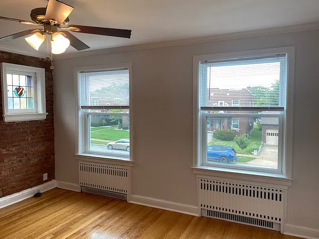 freshly painted living room with crown molding and lots of natural light