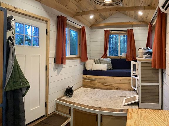 Living room looking from kitchen. Vaulted ceilings make it feel so much bigger! storage under the entire living room & couch