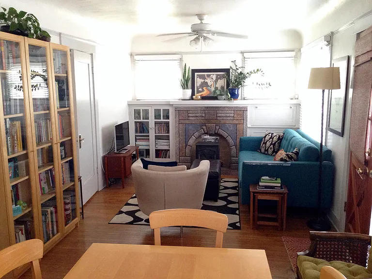 Front family room with bright windows on 3 of the walls & built in cabinets