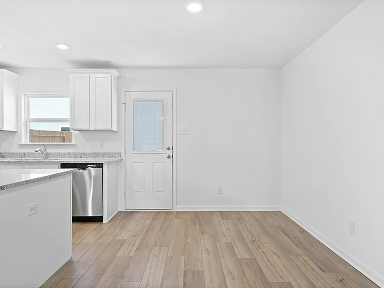 The dining room with a door to the backyard.