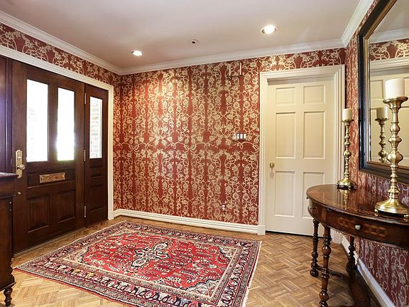 Lovely entry with Rusty Arena designer wallpaper. Front door replaced ('08). Hanging mirror excluded