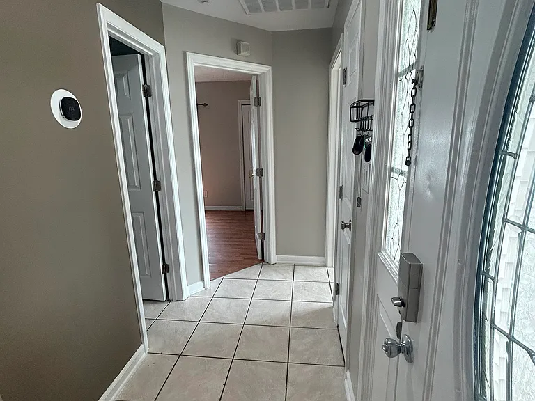 Small hallway leading to guess bathroom, front right bedroom, and guess bedroom