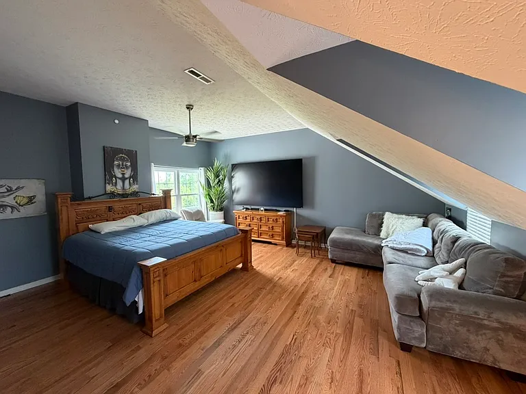 King bed, sectional couch, and 100" vizio in bonus room