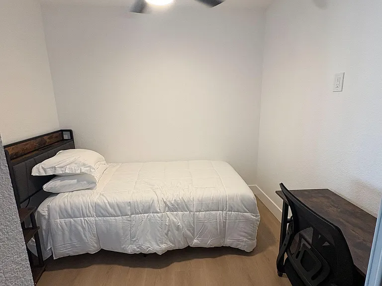 Private bedroom with a full bed, ceiling fan, and dedicated desk areaideal for studying or working from home.