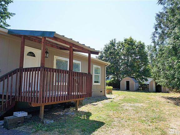Covered entry - outbuildings in back.