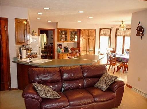 Family room with fireplace opens to kitchen.