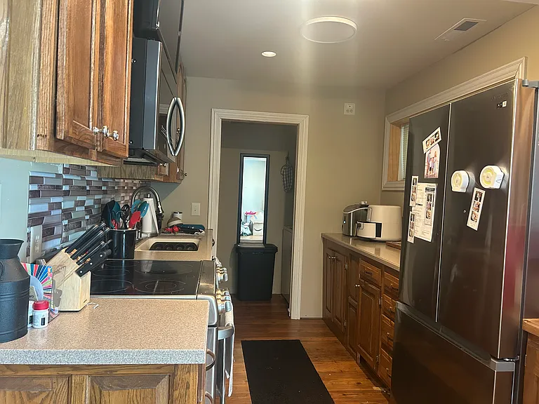 Kitchen, pantry and in unit washer and dryer through doorway in back