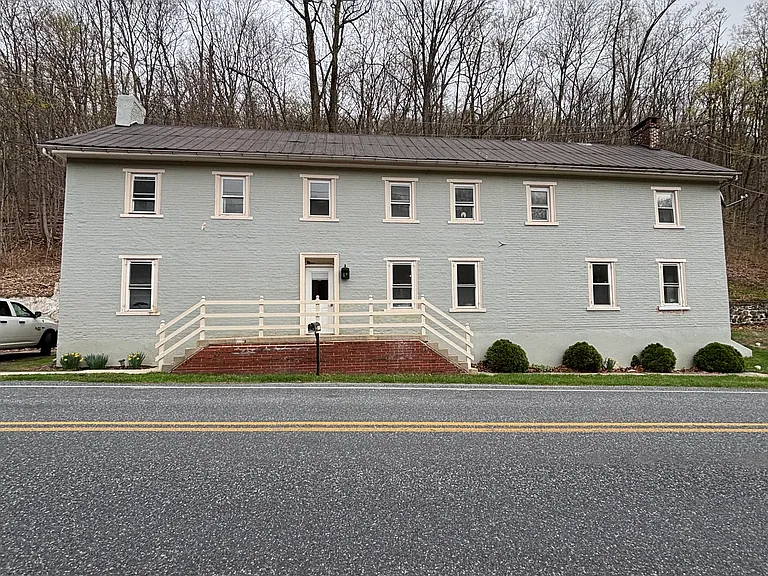 Parking to left of house and yard to right of the house.