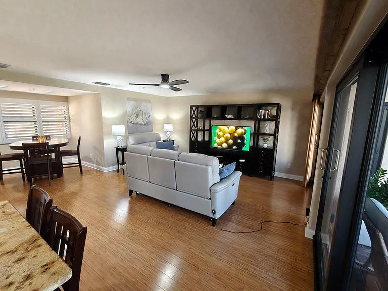 Living Room (w/ smart TV), with large glass doors to lanai.