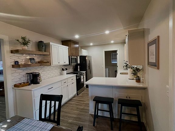 Fully stocked kitchen with microwave, air fryer, mixer.