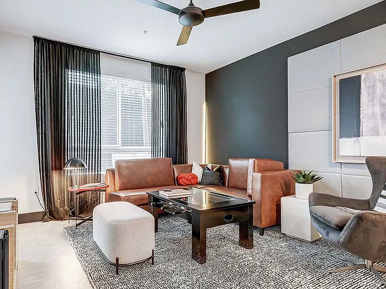 Griffis Platinum Triangle apartment living room with wood style flooring.