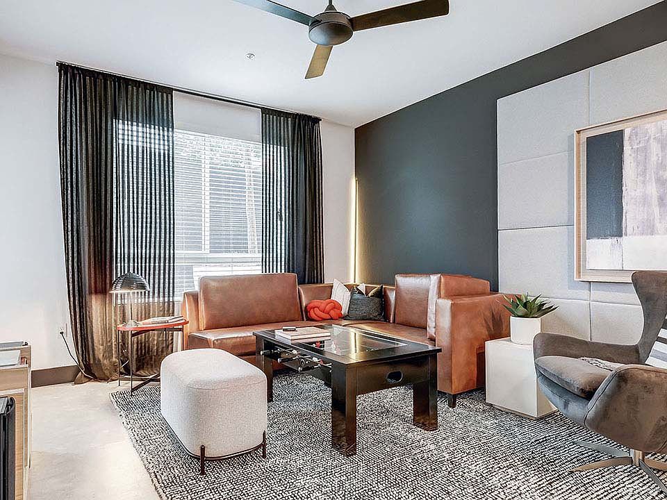 Griffis Platinum Triangle apartment living room with wood style flooring.