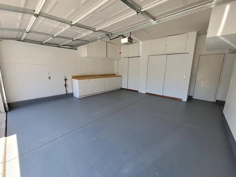 Freshly painted garage with plenty of built in storage