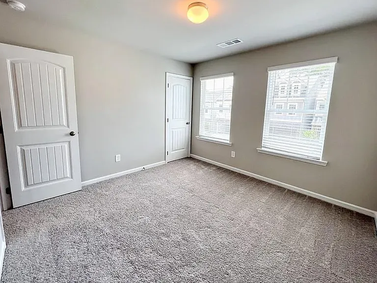 This is the second bedroom with it's own closet with a street view.