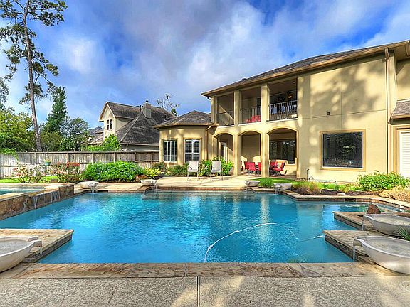  Enjoy PARADISE just outside your back door!  This Texas sized swimming pool features beautiful fountains and tropical landscaping!