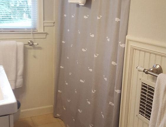 Hall bath with linen closet, tub and shower.
