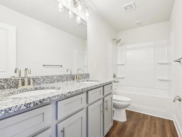 Secondary bathroom with tub shower and single vanity.