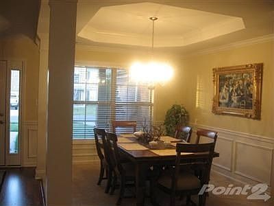 Formal dining room is spacious and dramatic. Accented with trey ceiling, chair rail and wainscoting.