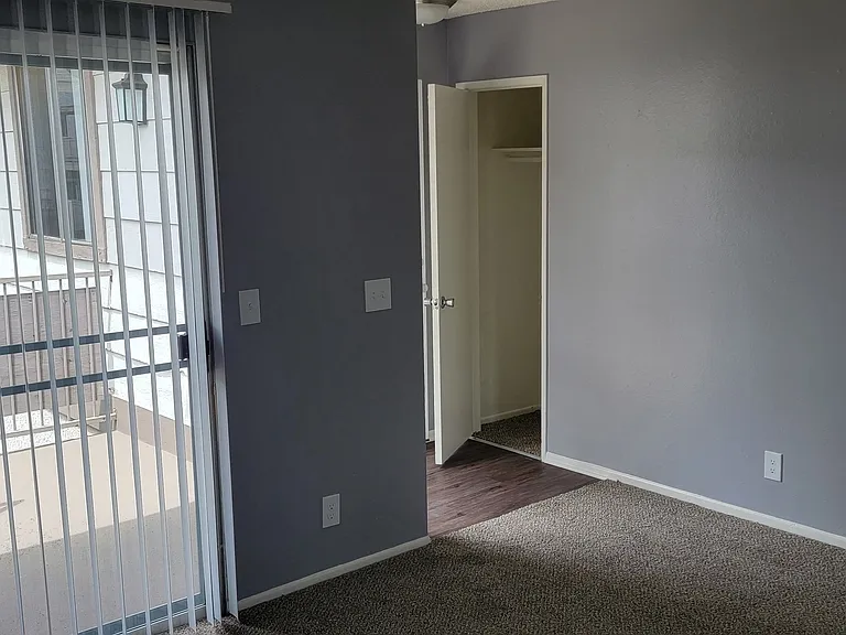 Living room view of enterance and front closet at Grand Oaks Apartments in Lake Elsinore, California.