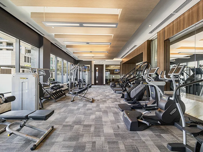 24-hour fitness center featuring TechnoGym strength training and cardio machines