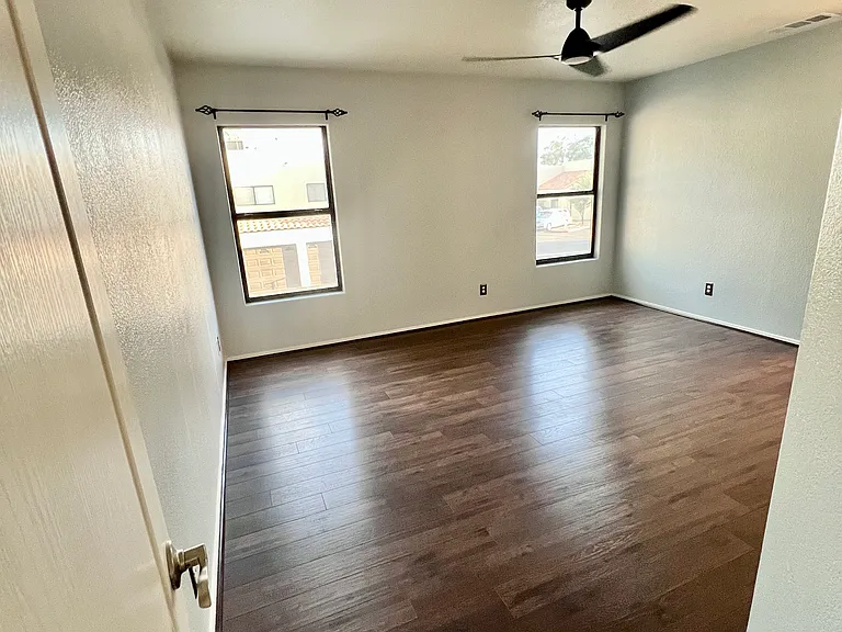 Master bedroom with upgraded floors, brand new tiled walk-in shower and ceiling fan July 2026
