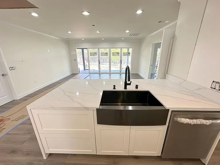 Brand new kitchen with stainless 
farmer sink, dish waster, stove, and ovens