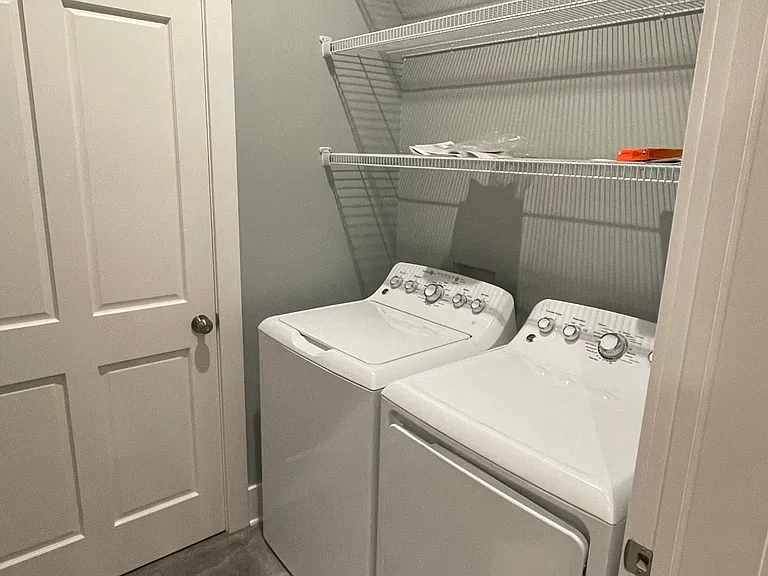 Full-sized laundry in apartment.