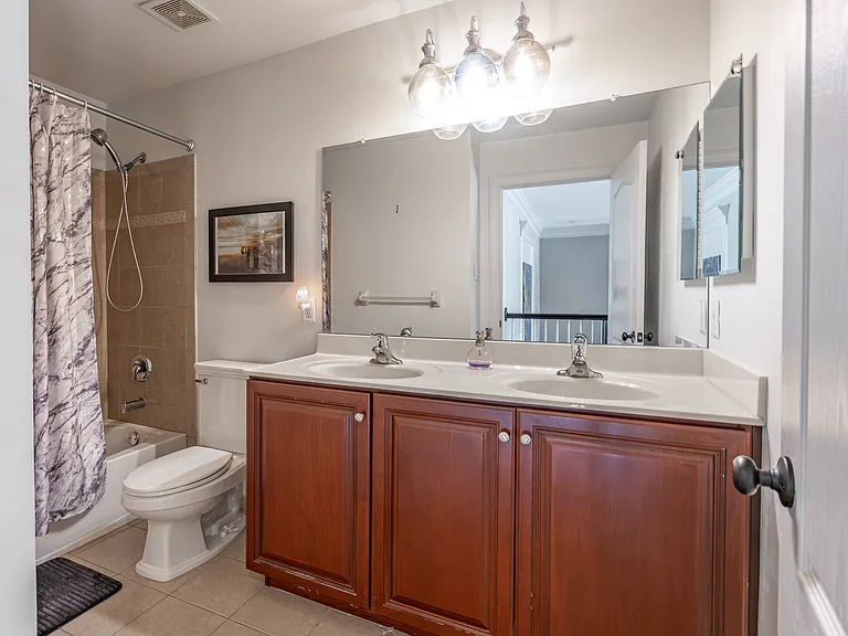 Bathroom with shower and double sink