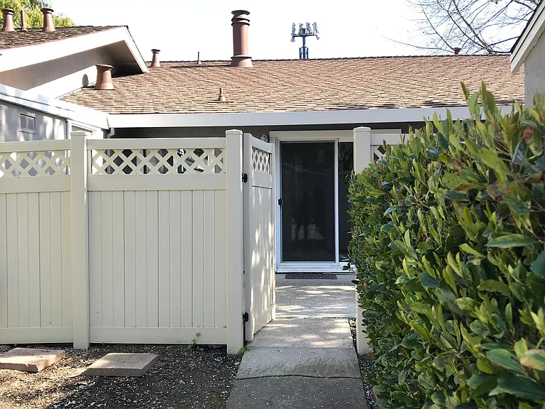 Backyard gate looking into dining room sliding door