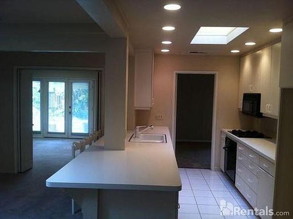Gallery kitchen with tons of carpet space, gas range/stove. Look at that beautiful skylight right where you want one!