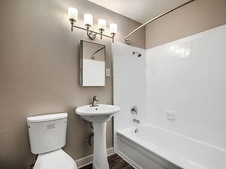 The Island Apartments bathroom vanity, toilet, and shower
