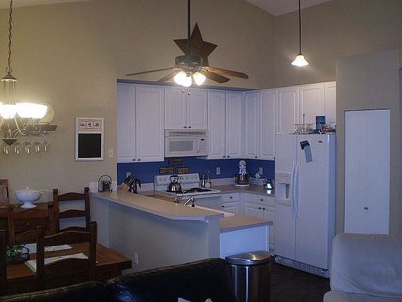 Tile floor in kitchen, cieling fan.