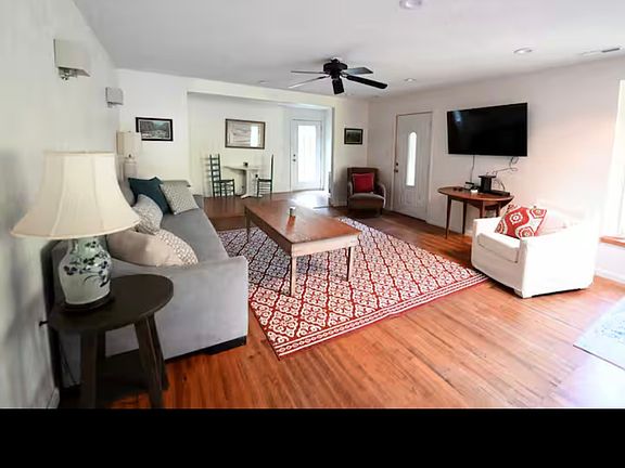 Open living room with Smart TV. Sky light. Bay window.