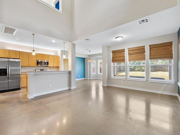 Looking into the first floor after entering the front door. The open concept first floor has a two story lofted ceiling so it feels extremely spacious and bright.
