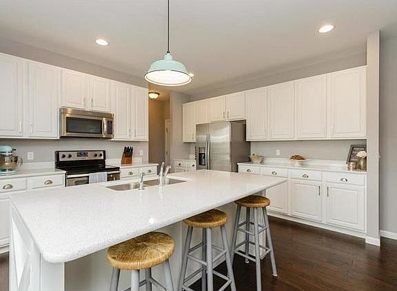 Kitchen with Stainless Steel Appliances, Quartz Counter Tops and Wood Floors