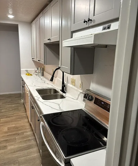 Kitchen with new cabinets, appliances, and new tiled floors