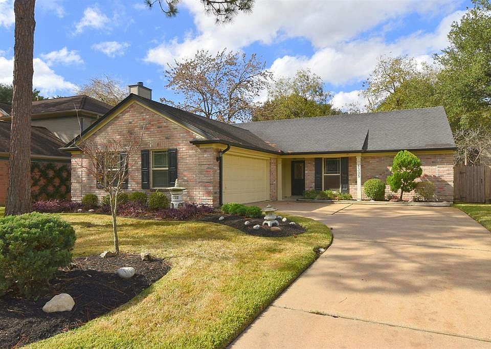 Lovely brick home in Copperfield featuring oversized finished garage with pegboard and storage, sprinkler system, double paned windows and large covered back patio.