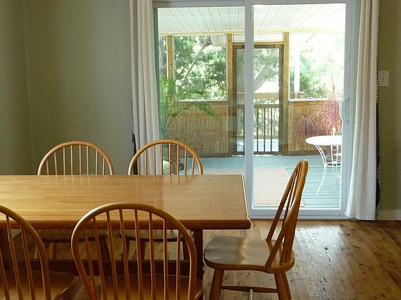 Nice view from kitchen, through pass-thru to dining area to entry porch and lovely trees outside.