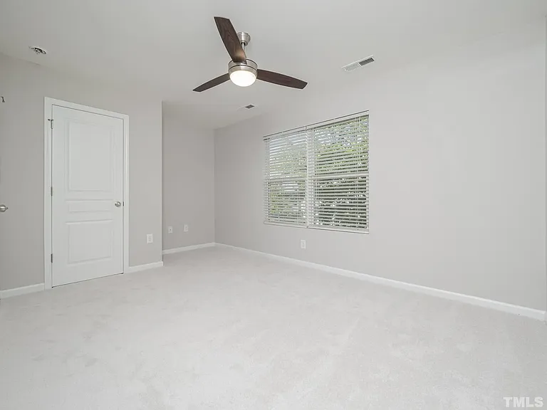 Welcome to the second bedroom. This space is spacious and can be used as a bedroom or office. Enjoy natural light with a scenic view.