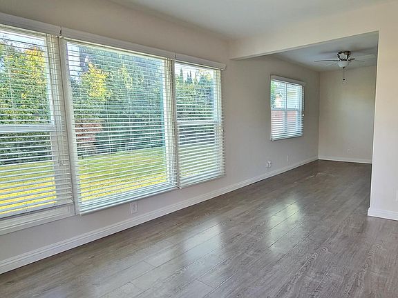 Floor to Ceiling Windows in the Living Area reveal the large private yard.