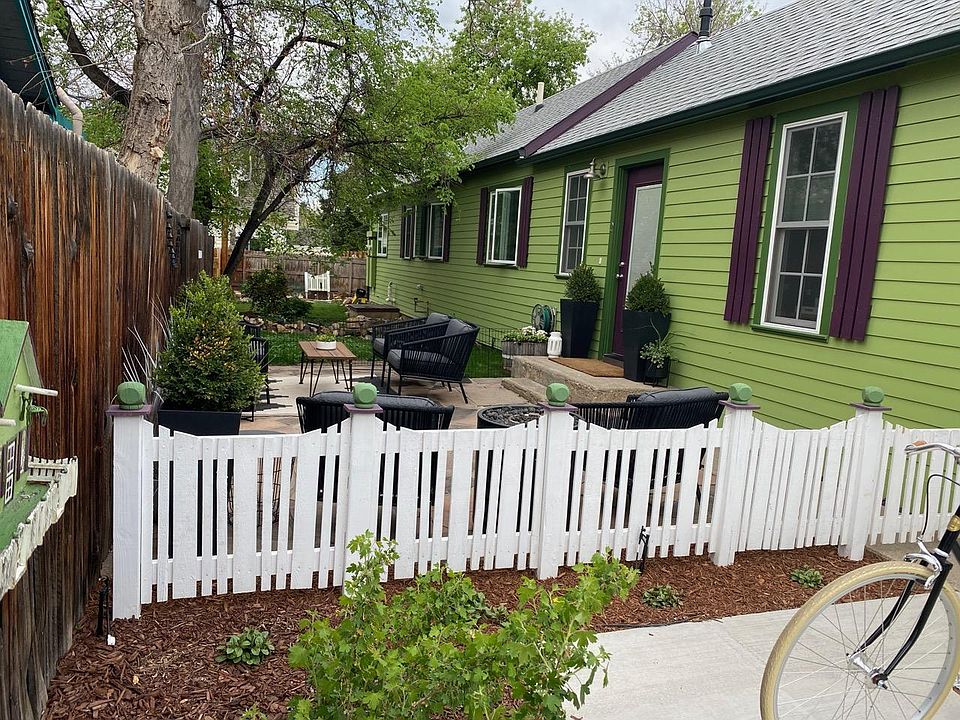 Entrance and patio perfect for entertaining - cute fence with landscaping.