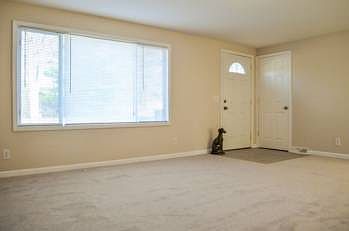 Front entry door with new tile landing and coat closet leads into the wide open living room (18x15) with lots of natural light flowing through the main windows, new carpet, paint and trim.