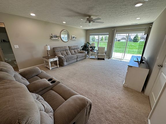 Cozy, comfortable family room with a ceiling fan and lots of natural sunlight. Gorgeous sliding glass doors take you straight to the patio!